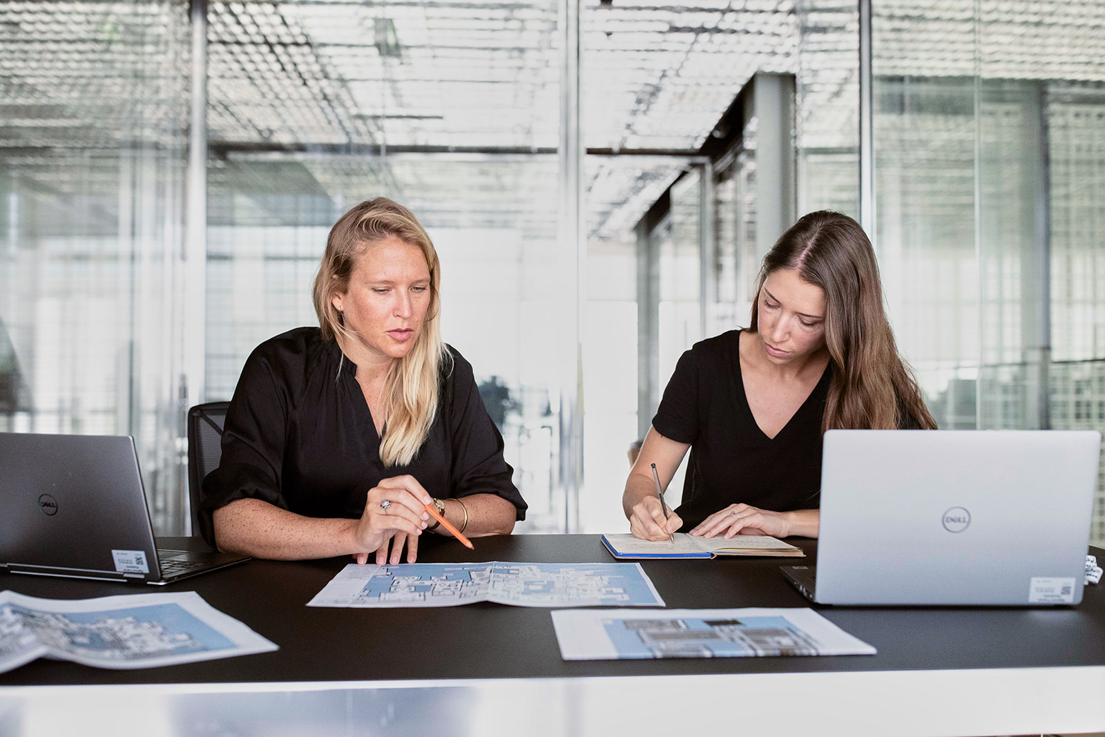 Audience and marketing strategy development A picture of two France Museum’s staff working on a blueprint of Louvre Abu Dhabi building