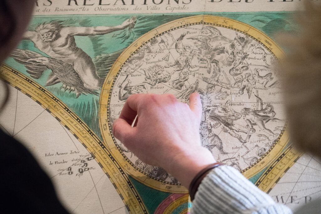 Hand showing the Theorica Panetarium at Louvre Abu Dhabi sustainability management page