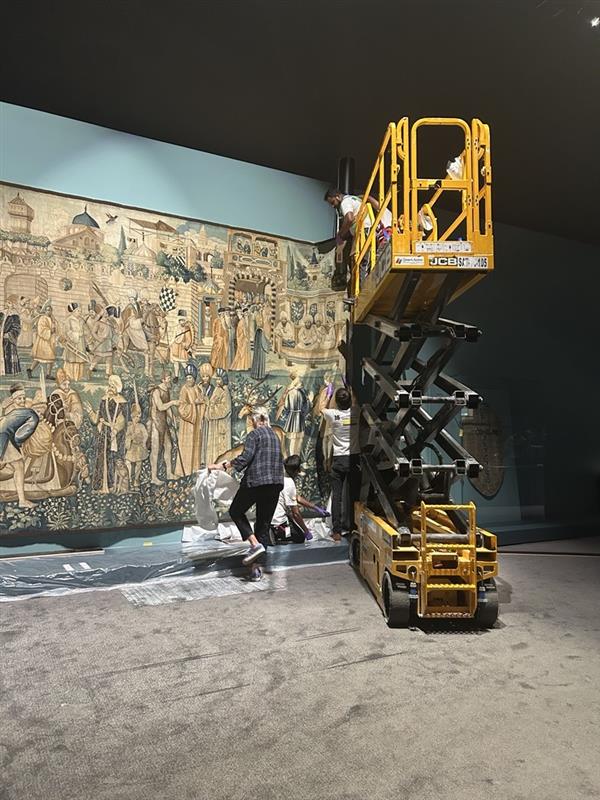 Installers at work setting up the exhibition 